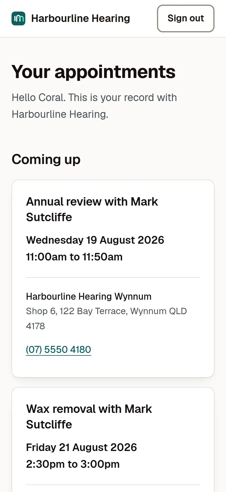 The client portal on a phone: the practice name at the top, a greeting by first name, and the patient's upcoming appointments as cards showing the appointment type, the audiologist, the date and time, and the clinic's address and phone number. No clinical or financial detail appears.